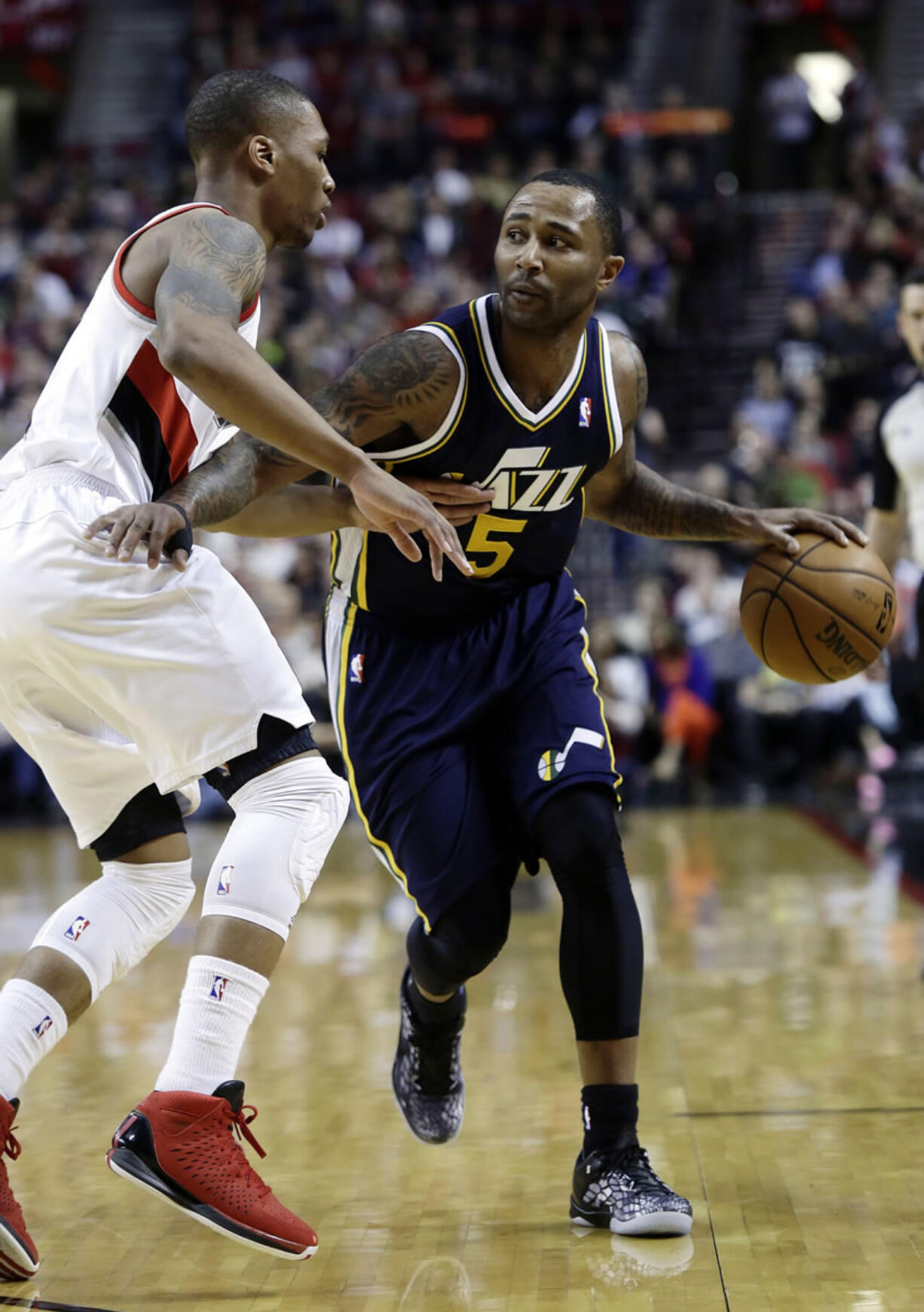 Utah Jazz guard Mo Williams, right, drives on Portland Trail Blazers guard Damian Lillard during the first quarter Friday.