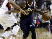 Utah Jazz guard Mo Williams, right, drives on Portland Trail Blazers guard Damian Lillard during the first quarter Friday.