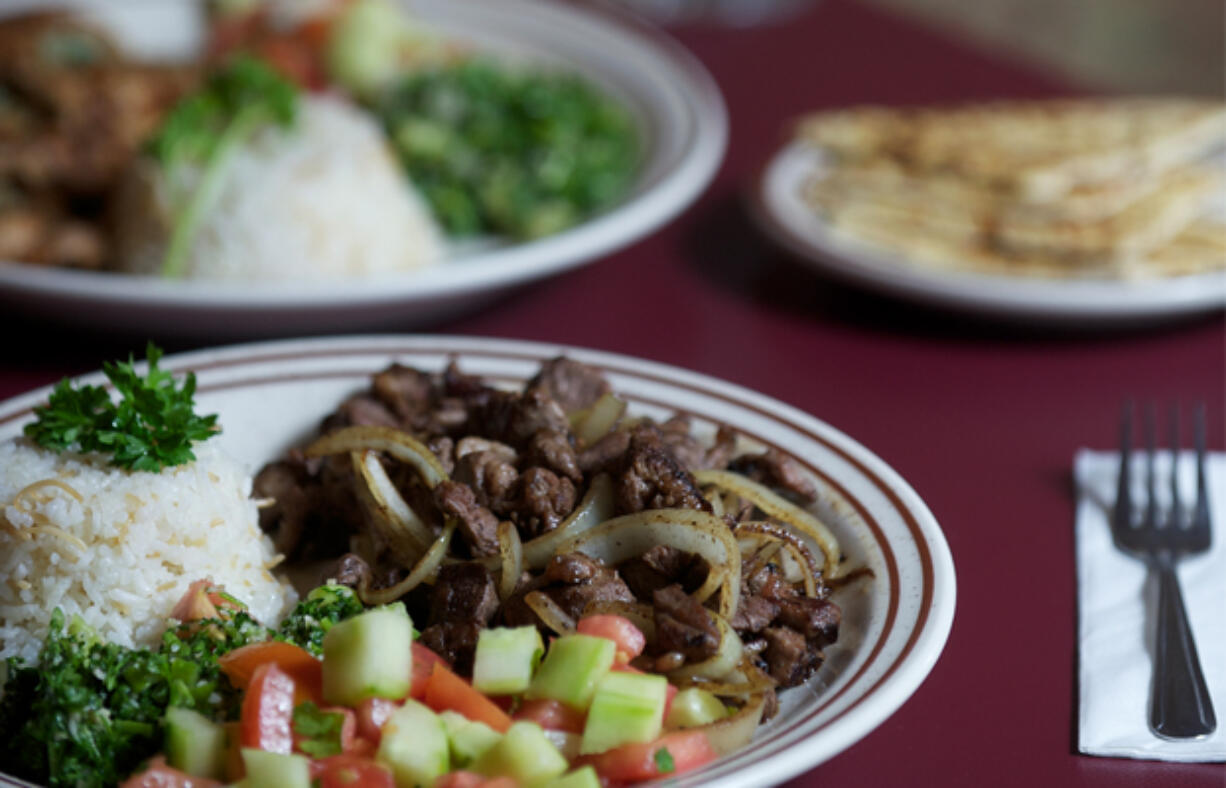 The Garlic Lemon Chicken and Lamb Shawarma, foreground, are two standout menu items available at the downtown Vancouver Jerusalem Cafe.