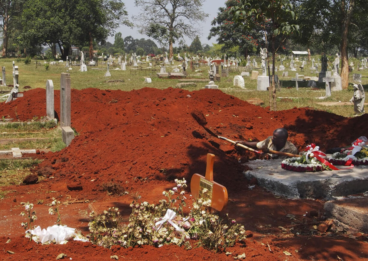 A man at the main cemetery in Nairobi digs graves Saturday in anticipation of more burials, both of Westgate Mall attack victims and of those who died from other causes.