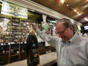 Bar owner Mick McHugh grimaces as he grips a a bottle of Champagne he intends to open when Seattle gets an NBA basketball team, after hearing rumors before an official announcement that the Sacramento Kings would not be sold to Seattle investors, Wednesday, May 15, 2013 in Seattle. NBA owners voted Wednesday to reject the Sacramento Kings' proposed move to Seattle, the latest in a long line of cities that have tried to land the franchise. The vote followed a recommendation made last month by the NBA's relocation committee and may have finally brought an end to an emotional saga that has dragged on for nearly three years.