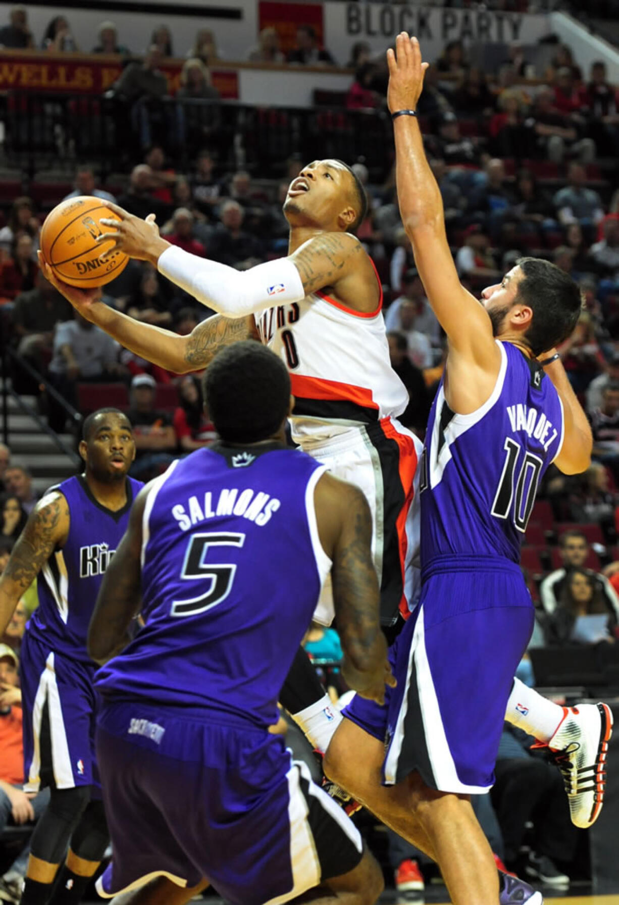 Portland Trail Blazers guard Damian Lillard (0) drives to the basket on Sacramento Kings guard Greivis Vasquez (10) during the first half of an NBA basketball game Sunday, Oct. 20, 2013, in Milwaukee.