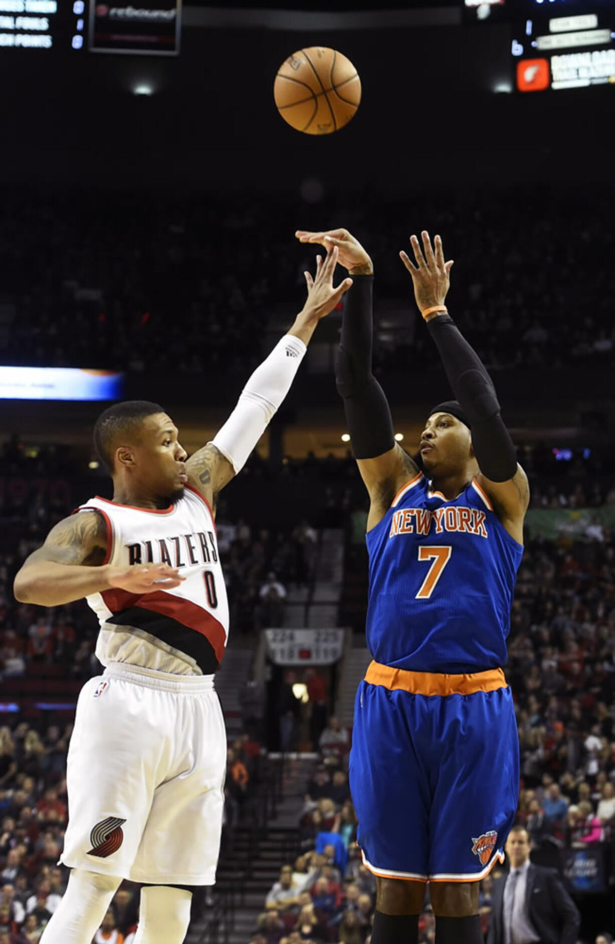 New York Knicks forward Carmelo Anthony (7) shoots over Portland Trail Blazers guard Damian Lillard (0) during the first half of an NBA basketball game in Portland, Ore., Saturday, Dec. 12, 2015.