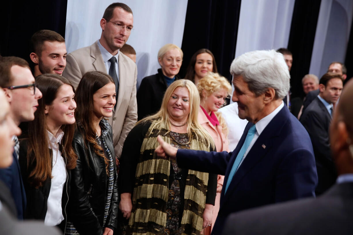 U.S. Secretary of State John Kerry, right, speaks with Kosovar Alumni of U.S. Government-funded programs after meeting Kosovo&#039;s Prime Minister Isa Mustafa at Pristina International Airport in Pristina, Kosovo, on Wednesday.