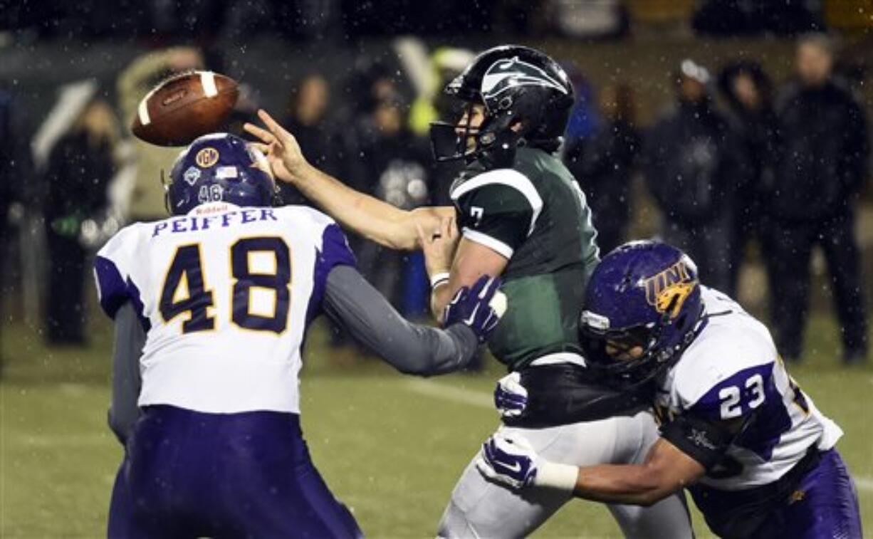 Portland State quarterback Alex Kuresa (7) passes the ball under pressure from Northern Iowa defensive lineman Wyatt Peiffer (48) and linebacker AJ Allen (23) during the second half of a second-round NCAA FCS playoff game on Saturday, Dec. 5, 2015, in Portland, Ore. Northern Iowa won 29-17.