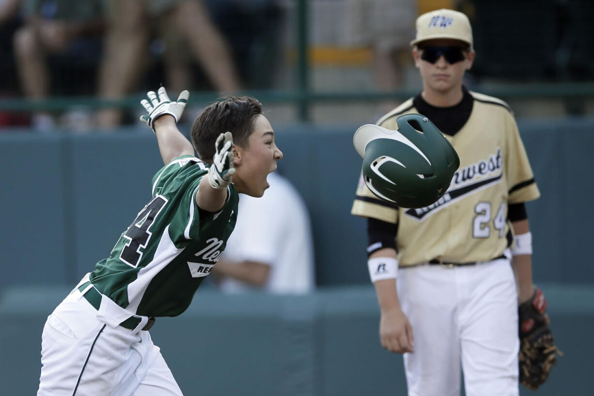 Westport, Conn.'s Chad Knight, left, celebrates after hitting the game-winning RBI-single as Sammamish's Will Armbruester looks on.