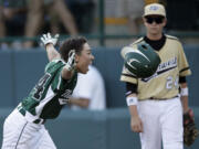 Westport, Conn.'s Chad Knight, left, celebrates after hitting the game-winning RBI-single as Sammamish's Will Armbruester looks on.