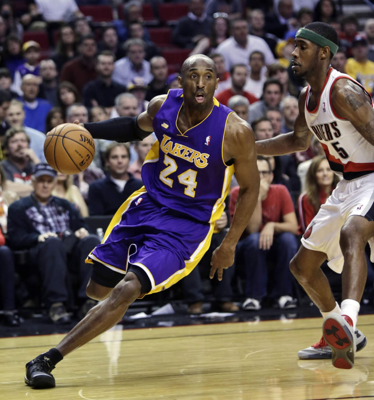 Los Angeles Lakers guard Kobe Bryant, left, drives on Portland Trail Blazers guard Will Barton.