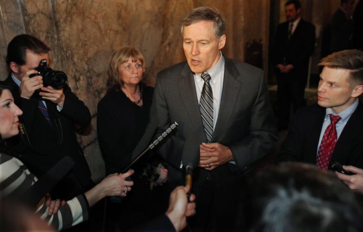 Standing in the wings of the Washington State House Chamber in Olympia on Monday with Rep. Jamie Pedersen, Gov.