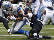 Detroit Lions wide receiver Golden Tate (15) pulls in a touchdown reception as New Orleans Saints cornerback Delvin Breaux tries to tackle in the first half of an NFL football game in New Orleans, Monday, Dec. 21, 2015.