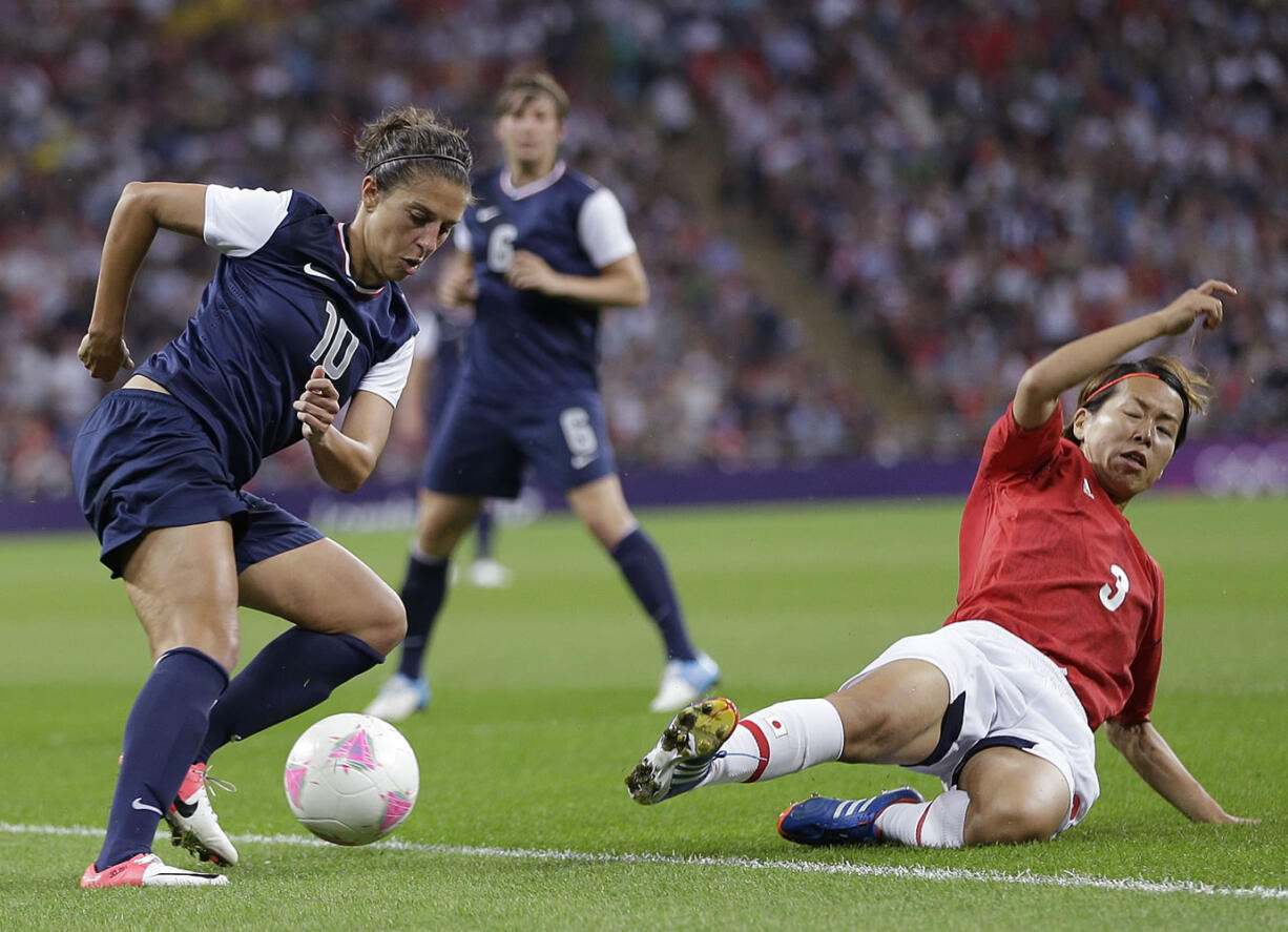 United States' Carli Lloyd (10) and Japan's Azusa Iwashimizu (3) fight for control of the ball during the women's soccer gold medal match at the 2012 Summer Olympics in London.