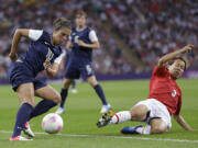 United States' Carli Lloyd (10) and Japan's Azusa Iwashimizu (3) fight for control of the ball during the women's soccer gold medal match at the 2012 Summer Olympics in London.