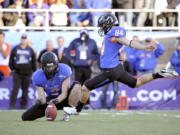 Boise State kicker Michael Frisina (84) kicks the go-ahead field goal in the closing minutes of Saturday's Las Vegas Bowl.