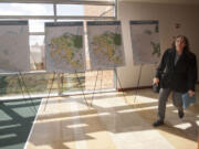 A woman walks past posters outlining land-use planning alternatives at the Clark County Public Service Center in Vancouver in April.