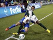 San Jose Earthquakes defender Dan Gargan, left, and Portland Timbers forward Rodney Wallace battle for the ball during the first half Sunday.