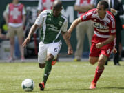 Portland Timbers forward Darlington Nagbe, left, and FC Dallas midfielder Andrew Jacobson chase down the ball during the first half Saturday.