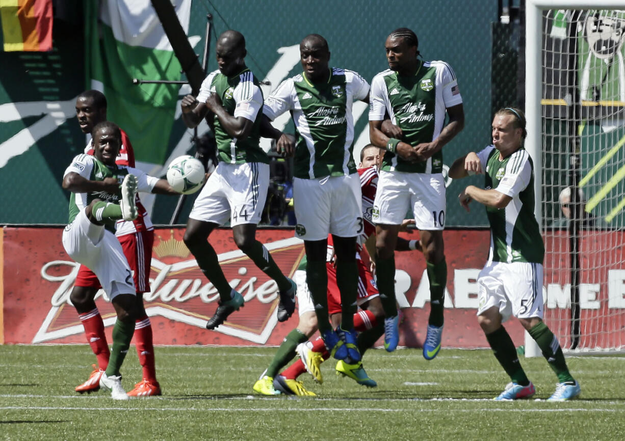 Portland Timbers players attempt to block a penalty kick during the second half of an MLS soccer game against FC Dallas in Portland, Ore., Saturday, June 15, 2013.  The Timbers won 1-0.