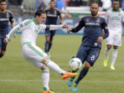 Portland Timbers midfielder Will Johnson, left, kicks the ball away from Los Angeles Galaxy midfielder Marcelo Sarvas during the first half Sunday.