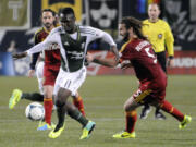 Portland Timbers' Kalif Alhassan (11)works against Real Salt Lake's Kyle Beckerman (5) during the first half of an MLS Soccer game in Portland, Ore., Saturday, Oct. 19, 2013.