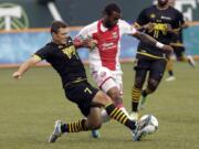 Tampa Bay Rowdies defender Frankie Sanfilippo, left, and Portland Timbers forward Frederic Piquionne battle for the ball during the first half of an MLS U.S.