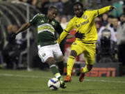 Portland Timbers forward Darlington Nagbe, left, and Columbus Crew midfielder Cedrick Mabwati fight for the ball during the second half of the MLS Cup championship soccer game Sunday, Dec. 6, 2015, in Columbus, Ohio. The Timbers won 2-1.