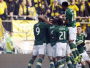 Portland Timbers celebrate their goal against the Columbus Crew during the first half of the MLS Cup championship soccer game, Sunday, Dec. 6, 2015, in Columbus, Ohio.