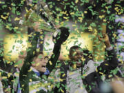 Portland Timbers forward Lucas Melano, left, of Argentina,and forward Fanendo Adi, of Nigeria, raise the trophy after defeating the Columbus Crew 2-1 in the MLS Cup championship soccer game Sunday, Dec. 6, 2015, in Columbus, Ohio.