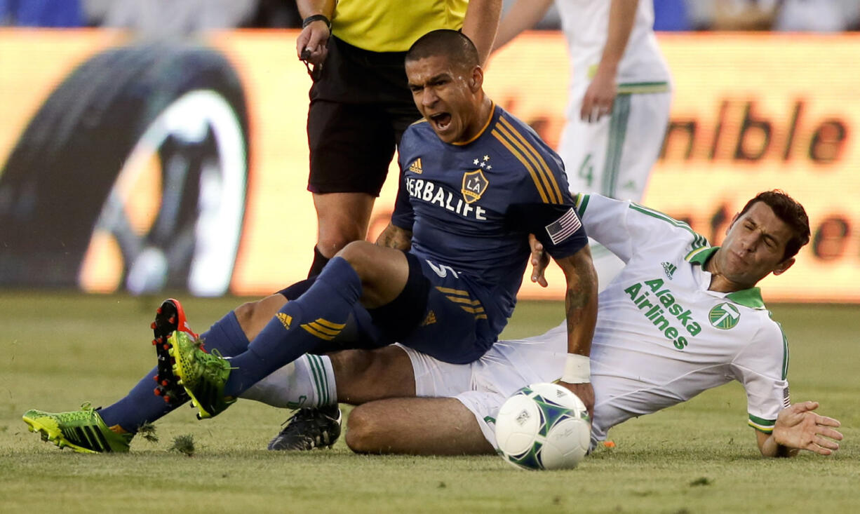 Galaxy midfielder Rafael Garcia, left, battles Timbers midfielder Diego Valeri.