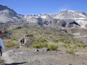 Hikers cross the flats on the north side of Mount St.