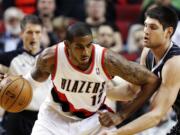 Portland Trail Blazers forward LaMarcus Aldridge (12) works against Orlando Magic center Nikola Vucevic during the first quarter Monday at the Rose Garden.