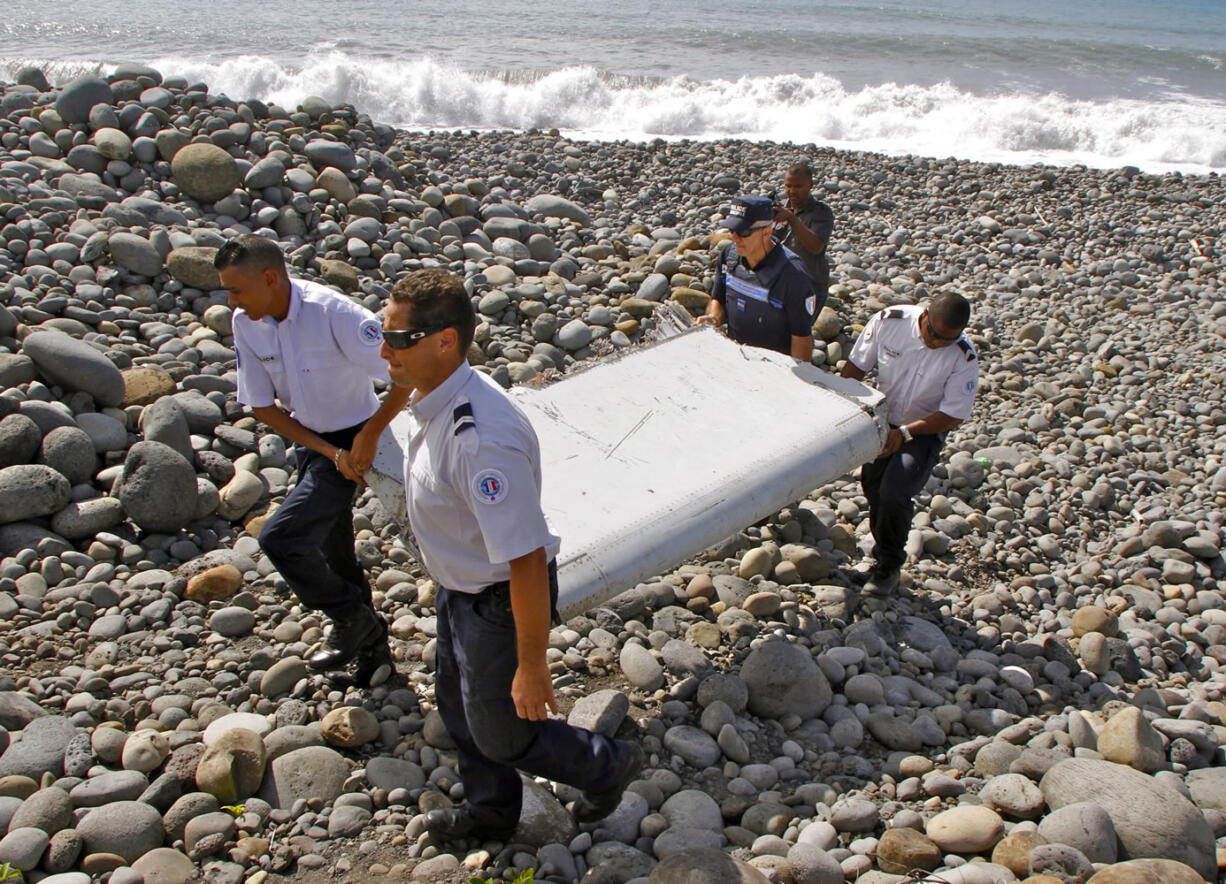 French police carry debris from a plane July 29 in Saint-Andre, Reunion Island. Australian officials said Thursday new analysis confirms they&#039;ve likely been searching in the right place for Malaysia Flight 370.