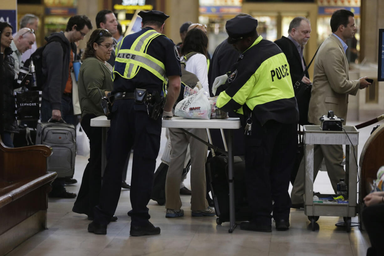 Amtrak Police officers screen bags at the 30th Street Station on Tuesday in Philadelphia.