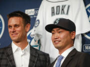 Seattle Mariners new outfielder Nori Aoki, right, poses for a photo with general manager Jerry Dipoto during a baseball press conference Thursday, December 3, 2015, in Seattle.