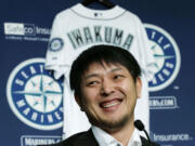 Seattle Mariners pitcher Hisashi Iwakuma smiles as he talks to reporters, Friday, Dec. 18, 2015, in Seattle. Iwakuma, who has been with the Mariners since 2012, signed a new one-year contract with the team for the 2016 season. (AP Photo/Ted S.