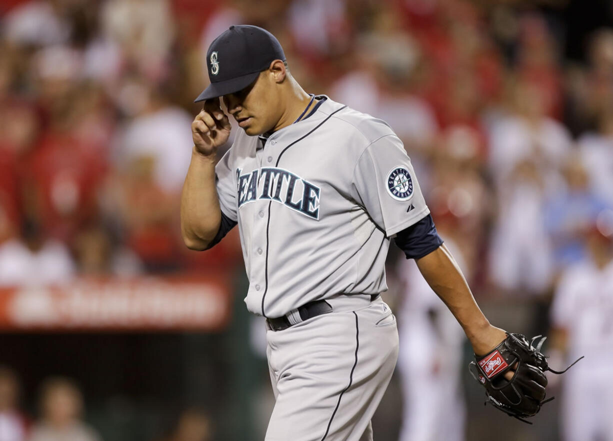 Seattle Mariners relief pitcher Yoervis Medina reacts after walking in the winning run against the Los Angeles Angels during the eight inning of a baseball game in Anaheim, Calif., Thursday, June 20, 2013.