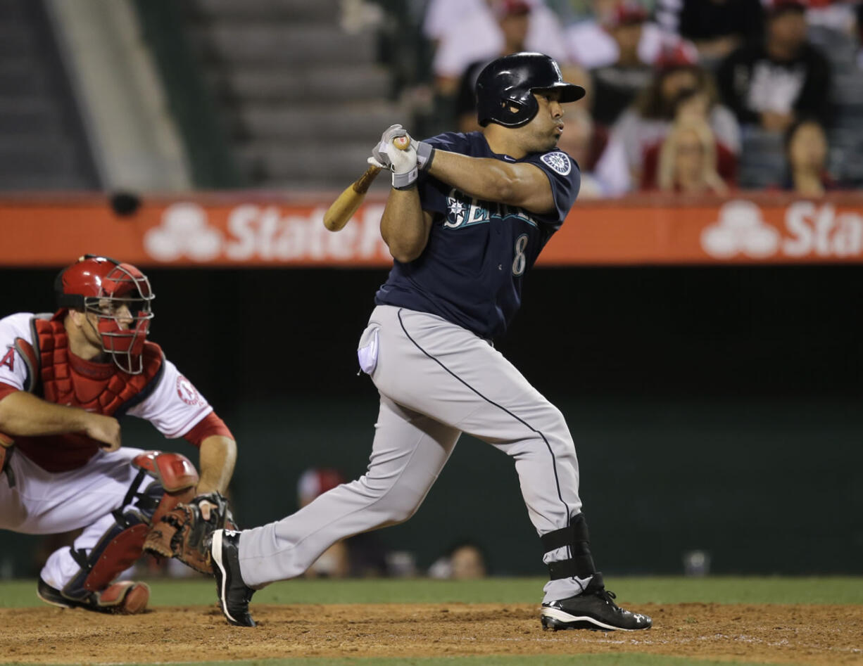 Seattle Mariners' Kendrys Morales hits a RBI single against the Los Angeles Angels during the 10th inning of a baseball game in Anaheim, Calif., Tuesday, June 18, 2013. (AP Photo/Jae C.