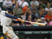 Seattle Mariners' Brad Miller drives the ball to right field for a three-run home run against the Houston Astros in the eighth inning during a baseball game Friday.