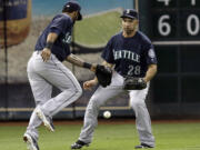 The ball drops between left fielder Raul Ibanez (28) and shortstop Brendan Ryan in a 3-2 loss at Houston.