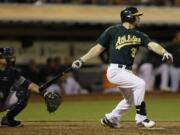 Oakland Athletics' Brandon Moss swings for the game-winning home run off Seattle Mariners' Carter Capps in the ninth inning Monday.