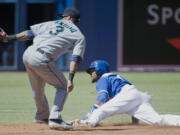 Toronto's Emilio Bonifacio, right, steals second base as Seattle shortstop Robert Andino, left, is late on the tag during second inning Sunday.