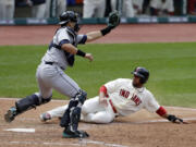 Cleveland Indians' Mike Aviles, right, scores as Seattle Mariners catcher Jesus Montero waits for the ball in the sixth inning Saturday at Cleveland.