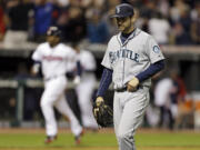 Seattle Mariners relief pitcher Lucas Luetge, foreground, walks off the field after giving up a game-winning, three-run home run to Cleveland Indians' Jason Kipnis in the 10th inning Friday.