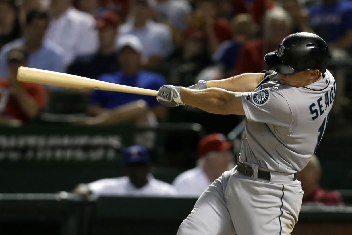 Seattle Mariners' Kyle Seager follows through on a two-run home run off a pitch from Texas Rangers' Robbie Ross in the 10th inning of a baseball game on Wednesday, July 3, 2013, in Arlington, Texas.