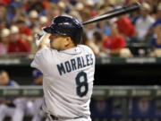 Seattle Mariners designated hitter Kendrys Morales follows through on a two-run single during the sixth inning of a baseball game Tuesday, July 2, 2013, in Arlington, Texas. +(AP Photo/John F.