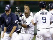 Tampa Bay Rays' Jason Bourgeois, center, celebrates with teammates after his ninth inning walk off hit off Seattle Mariners relief pitcher Danny Farquhar during a baseball game Wednesday, Aug. 14, 2013, in St. Petersburg, Fla. Rays' Matt Joyce scored on the hit.  The Rays won the game 5-4.