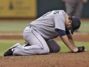 Seattle Mariners starting pitcher Joe Saunders reacts after a fifth-inning single by Tampa Bay Rays' Sam Fuld went off his glove.