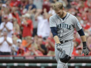 Seattle Mariners' Michael Saunders throws his batting helmet after striking out to end the fifth inning Saturday.