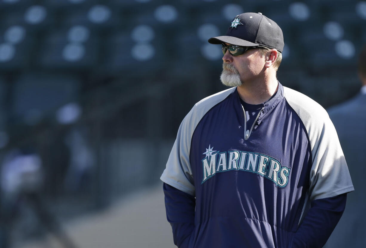 Seattle Mariners manager Eric Wedge watches batting practice before a baseball game against the Houston Astros in Seattle.