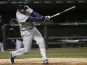 Seattle Mariners' Franklin Gutierrez hits a two-run double off Chicago White Sox starting pitcher Jose Quintana, scoring Dustin Ackley and Brendan Ryan, during the fifth inning Friday.