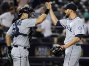 Seattle Mariners closer Tom Wilhelmsen celebrates with catcher Jesus Montero after defeating the New York Yankees, 3-2 on Thursday.